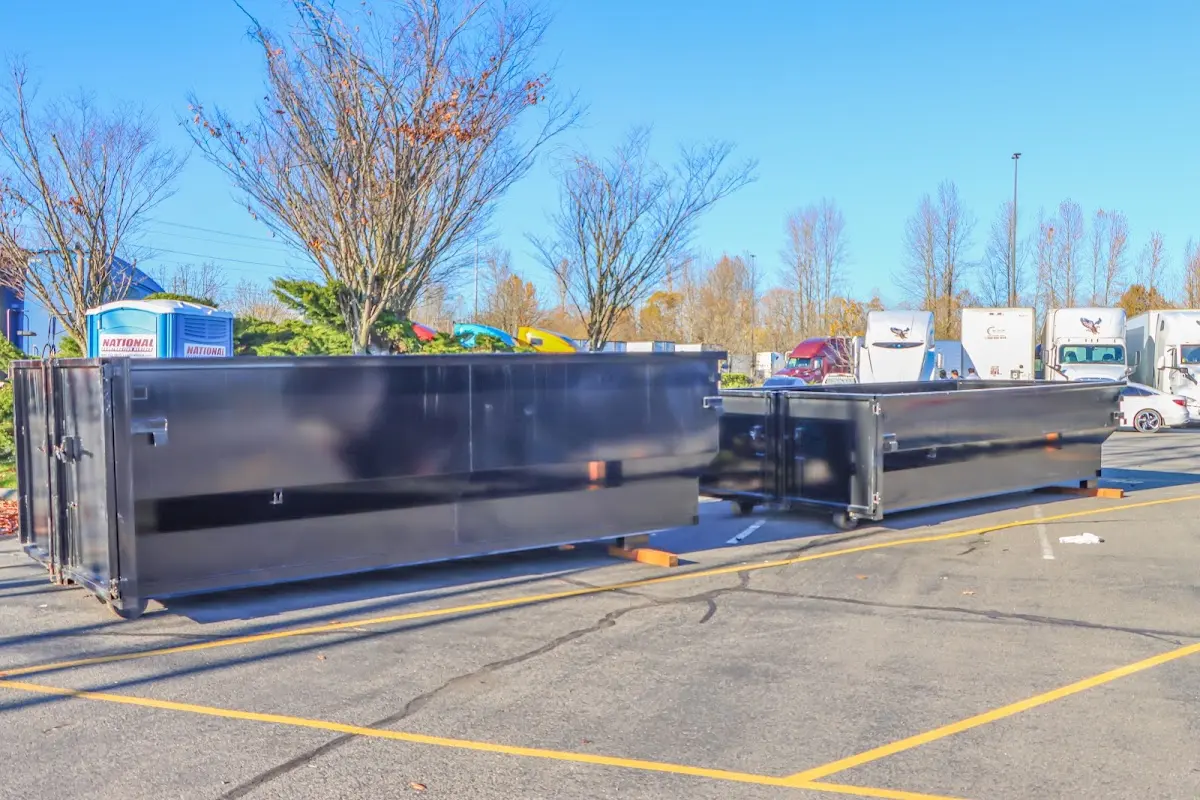 Professional dumpster rental service with roll-off container on residential driveway in Lake Morton-Berrydale